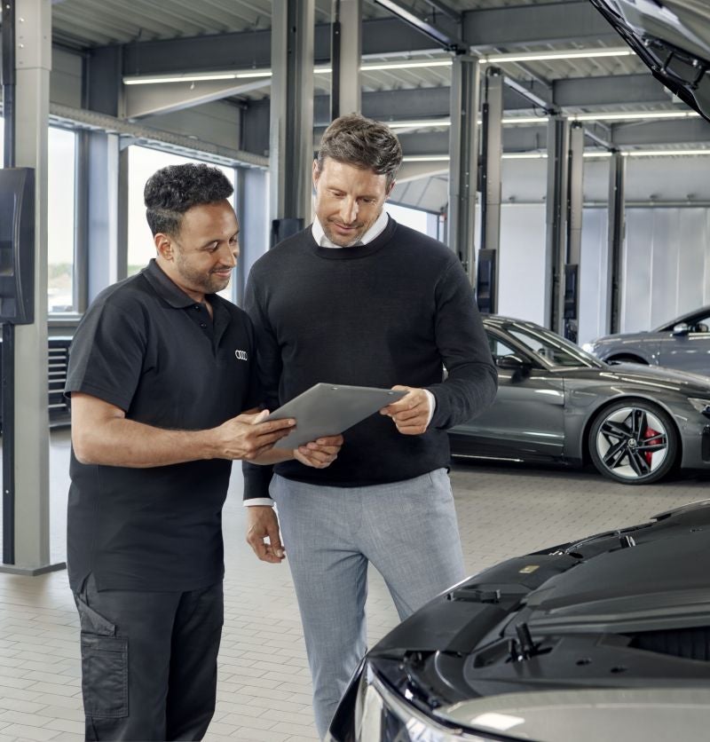 Audi service technician performing inspection